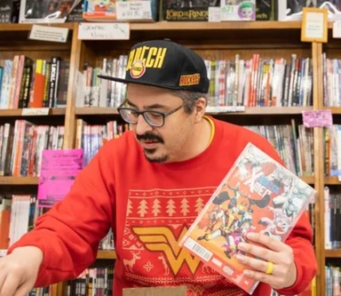 Man in red sweater searching comics