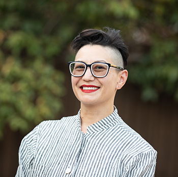 Woman smiling against natural background